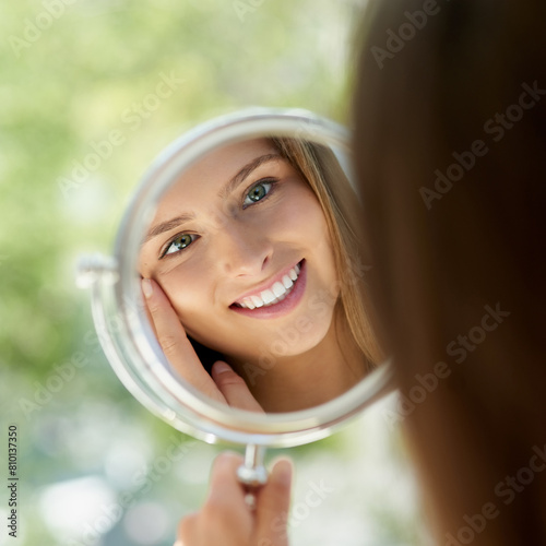 Foto Woman, mirror and anti aging or smile in home, hands and skincare or thinking with natural glowing reflection