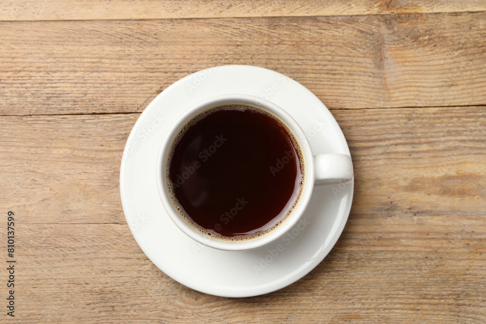 Cup of aromatic coffee on wooden table, top view Cup of aromatic coffee on wooden table, top view