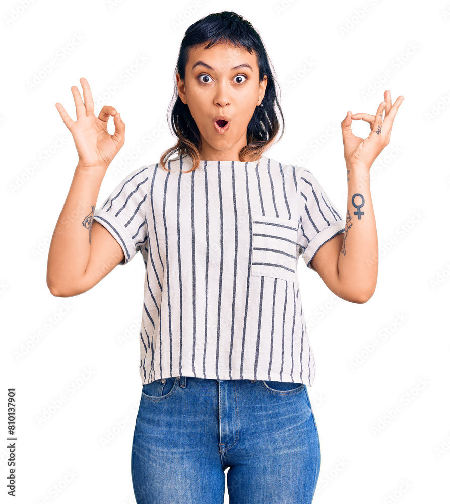 Young woman wearing casual clothes looking surprised and shocked doing ok approval symbol with fingers. crazy expression Young woman wearing casual clothes looking surprised and shocked doing ok approval symbol with fingers. crazy expression