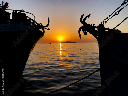 Sunset in between boats at the Adriatic Sea in Rovinj - Croatia 