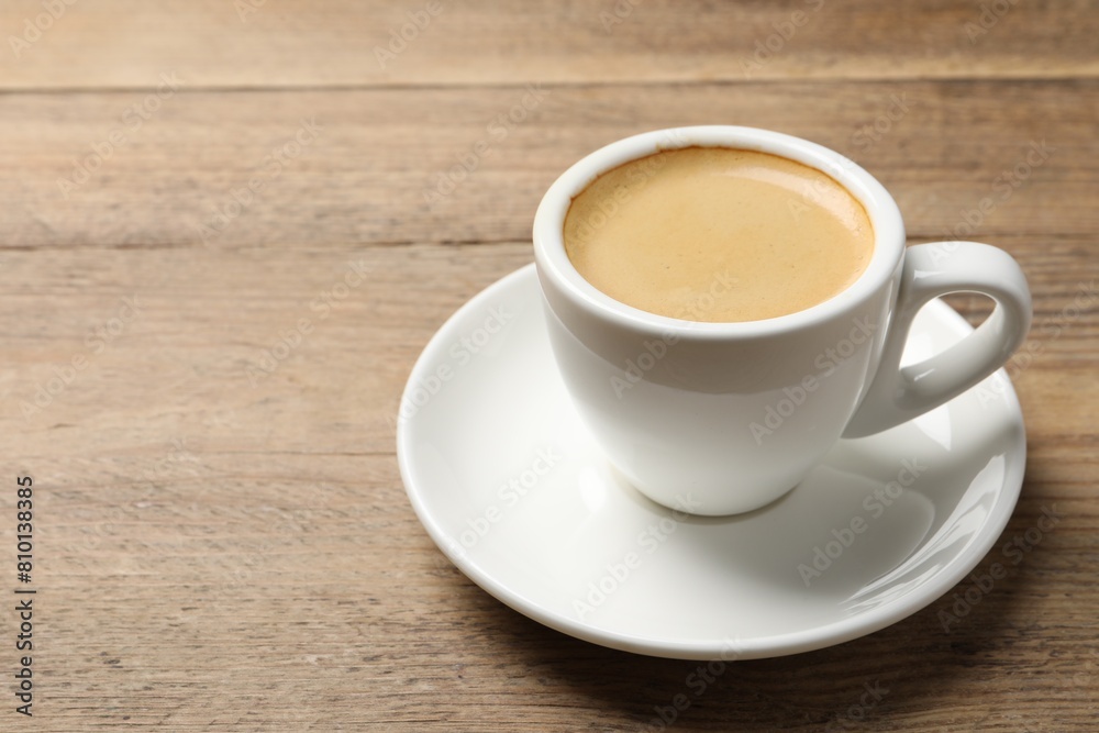 Aromatic coffee in cup on wooden table. Space for text Aromatic coffee in cup on wooden table. Space for text