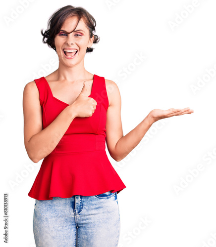 Beautiful young woman with short hair wearing casual style with sleeveless shirt showing palm hand and doing ok gesture with thumbs up, smiling happy and cheerful