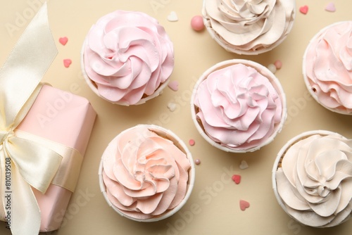Wallpaper Mural Delicious birthday cupcakes, gift box and sprinkles on beige background, flat lay Torontodigital.ca