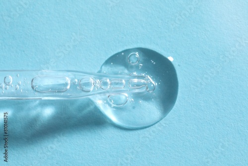 Wallpaper Mural Glass pipette and transparent liquid on light blue background, top view Torontodigital.ca