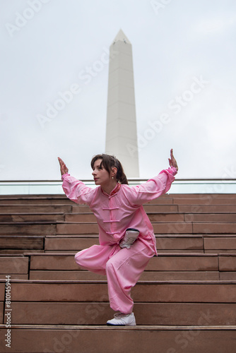 Woman doing Tai chi in city landscape