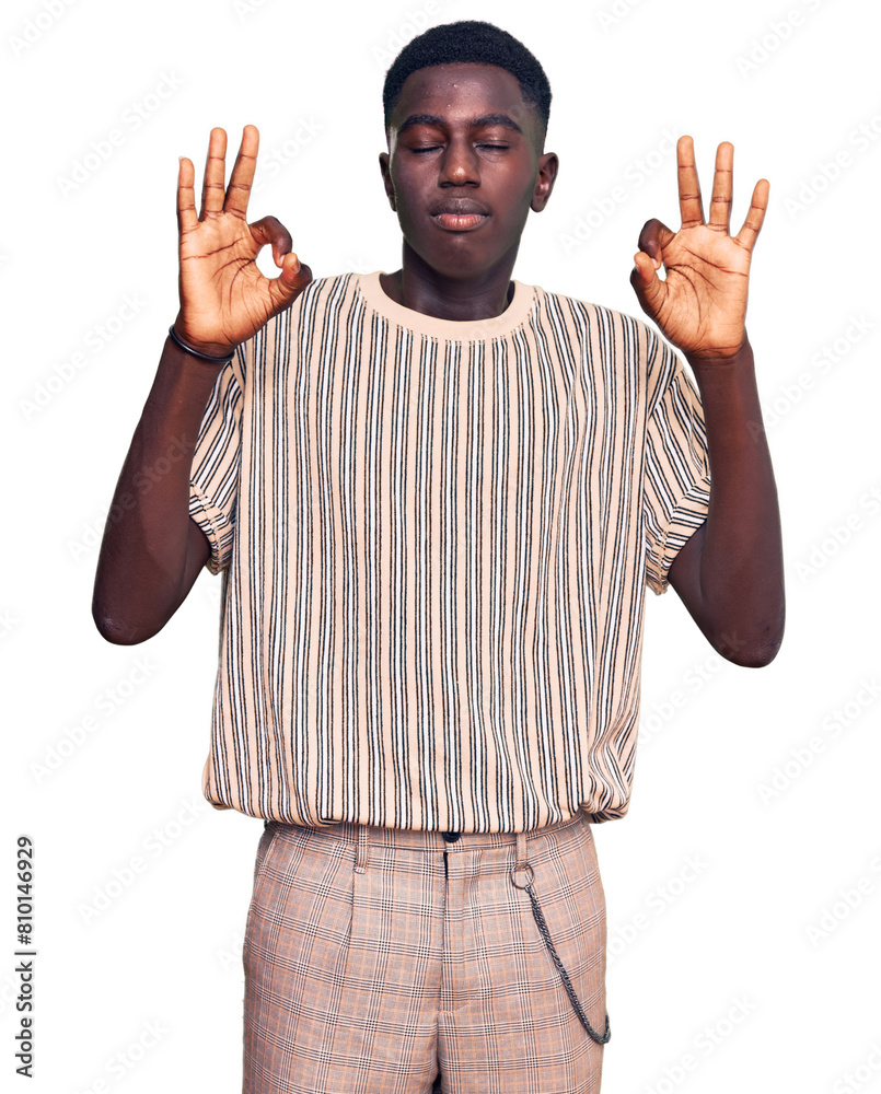 Fototapeta premium Young african american man wearing casual clothes relax and smiling with eyes closed doing meditation gesture with fingers. yoga concept.