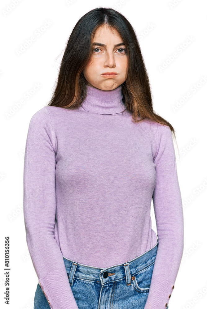 Young beautiful teen girl wearing turtleneck sweater puffing cheeks with funny face. mouth inflated with air, crazy expression. Young beautiful teen girl wearing turtleneck sweater puffing cheeks with funny face. mouth inflated with air, crazy expression.