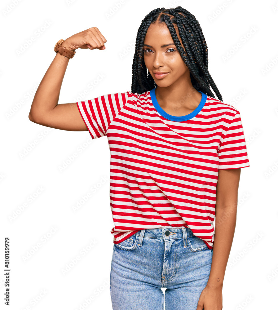 Beautiful hispanic woman wearing casual clothes strong person showing arm muscle, confident and proud of power