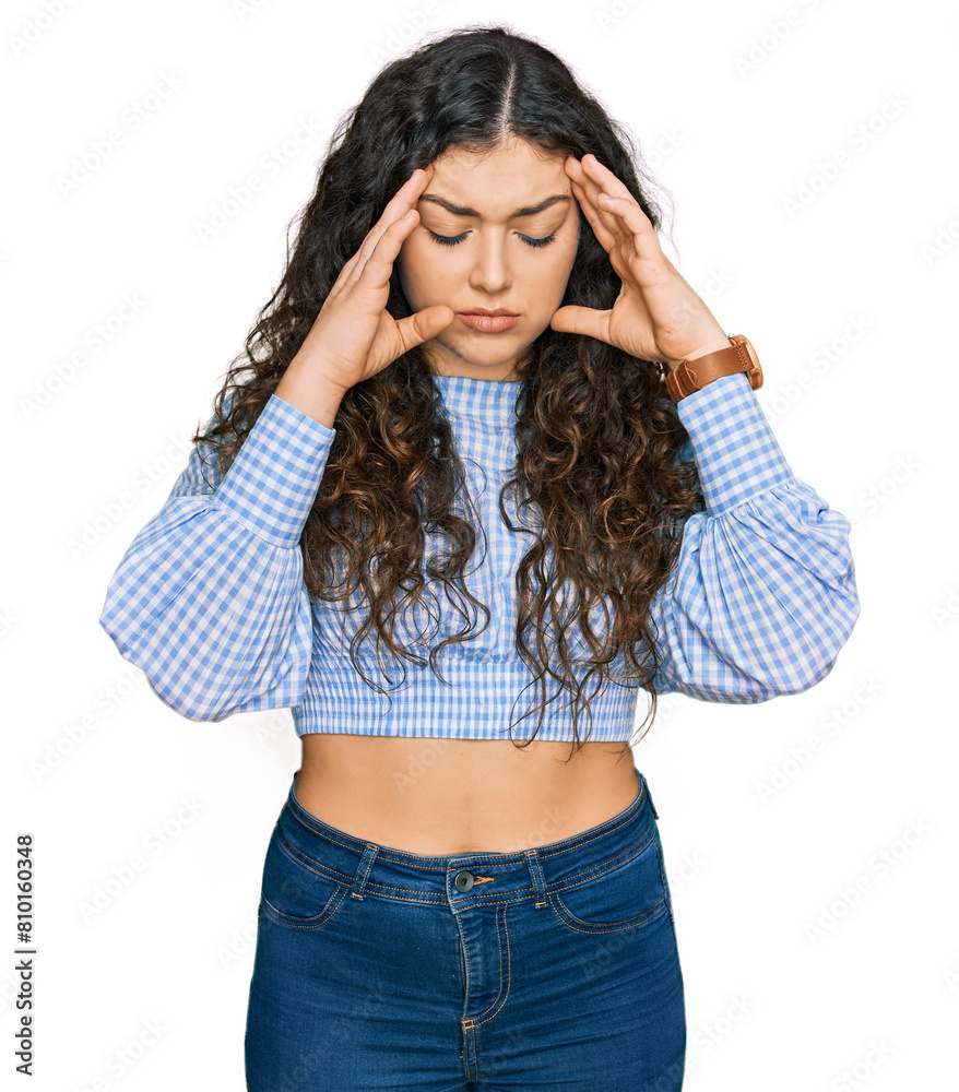 Young hispanic girl wearing casual clothes with hand on head, headache because stress. suffering migraine. Young hispanic girl wearing casual clothes with hand on head, headache because stress. suffering migraine.