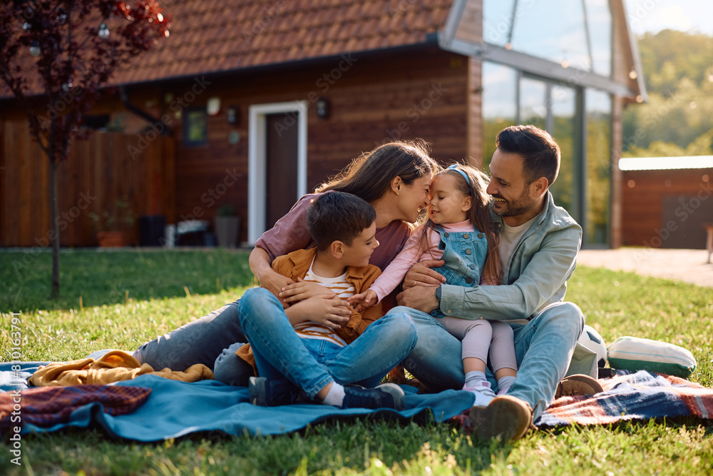Happy family enjoying in their backyard on spring day.