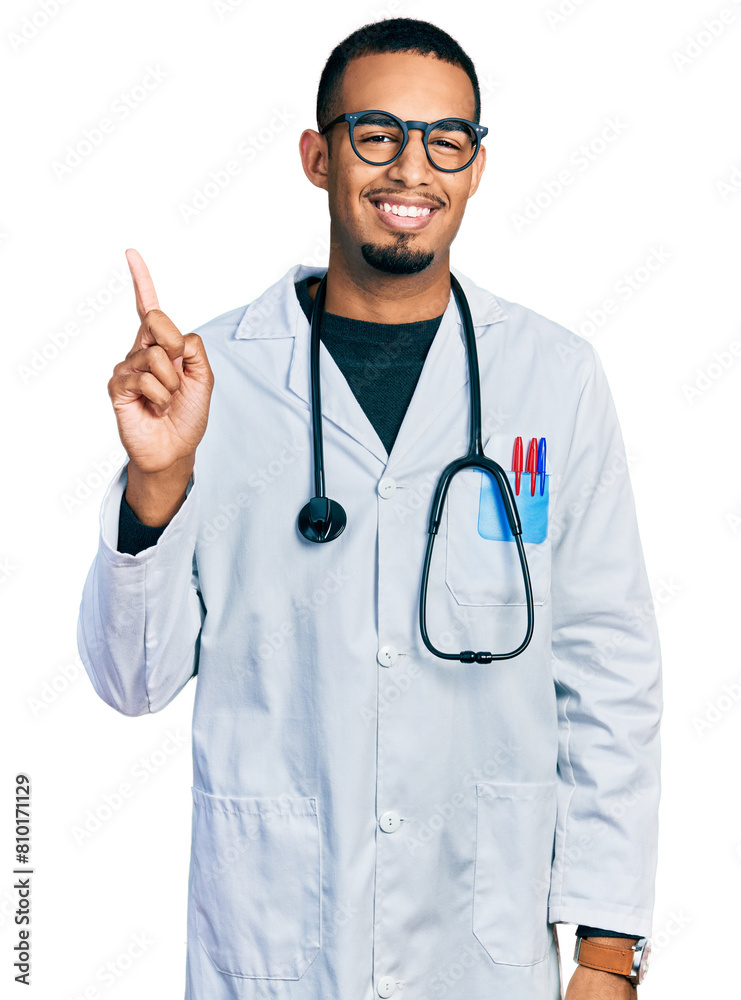 Young african american man wearing doctor uniform and stethoscope pointing finger up with successful idea. exited and happy. number one. Young african american man wearing doctor uniform and stethoscope pointing finger up with successful idea. exited and happy. number one.
