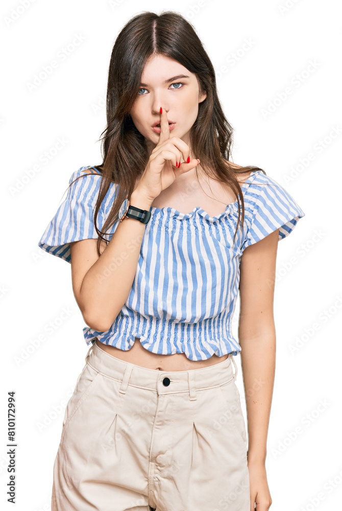 Young beautiful caucasian girl wearing casual clothes asking to be quiet with finger on lips. silence and secret concept. Young beautiful caucasian girl wearing casual clothes asking to be quiet with finger on lips. silence and secret concept.