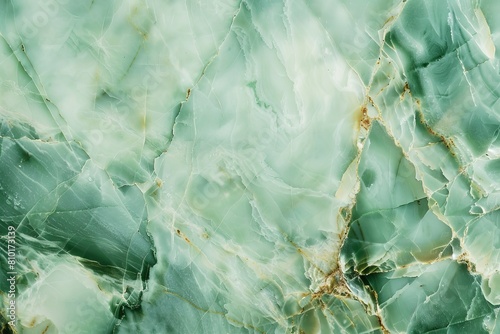 High-resolution image showcasing the beautiful, natural patterns of a green marble surface with intricate golden veins, perfect for backgrounds or luxury design elements