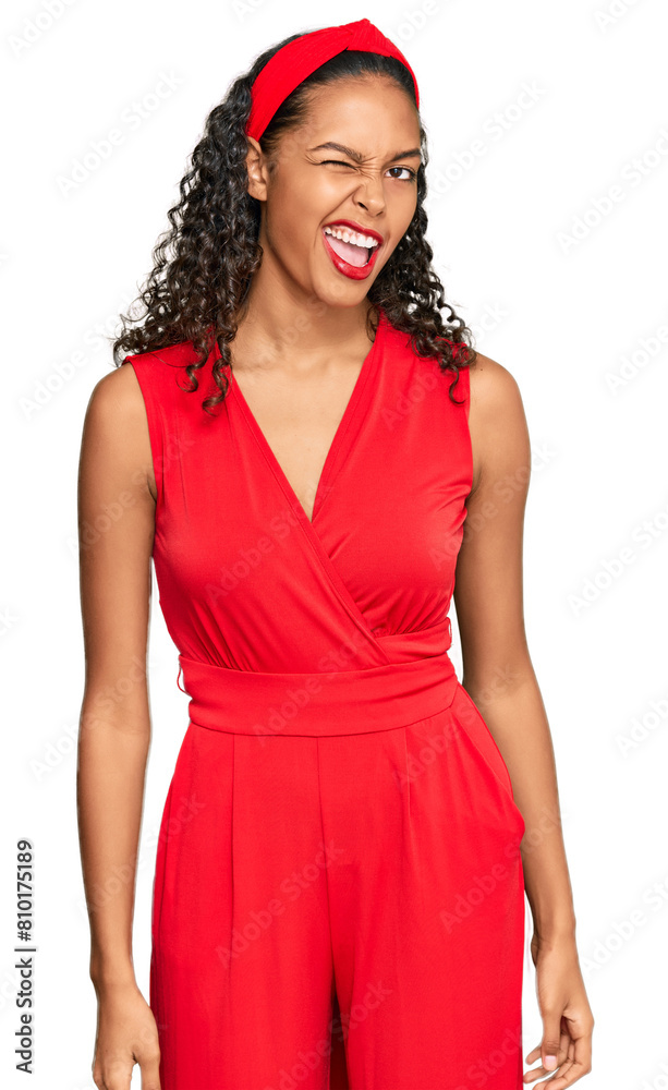 Young african american girl wearing elegant and sexy look winking looking at the camera with sexy expression, cheerful and happy face. Young african american girl wearing elegant and sexy look winking looking at the camera with sexy expression, cheerful and happy face.