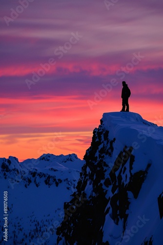 Silhouette against sunset perched snowy peak witnessing colors twilight