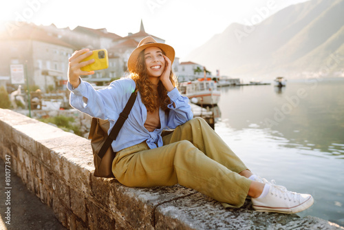 Female tourist taking selfie photos on sightseeing.  Selfie time. Lifestyle, adventure, nature, active life. © maxbelchenko