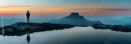 Lone figure mountain zenith outlined fading sunlight silent witness reflection peace photo