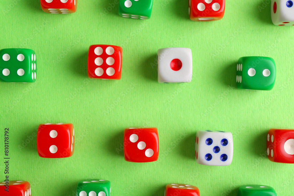 Many color game dices on green background, flat lay Many color game dices on green background, flat lay
