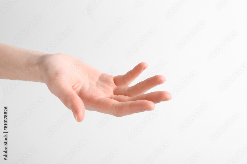 Woman holding hand on white background, closeup Woman holding hand on white background, closeup