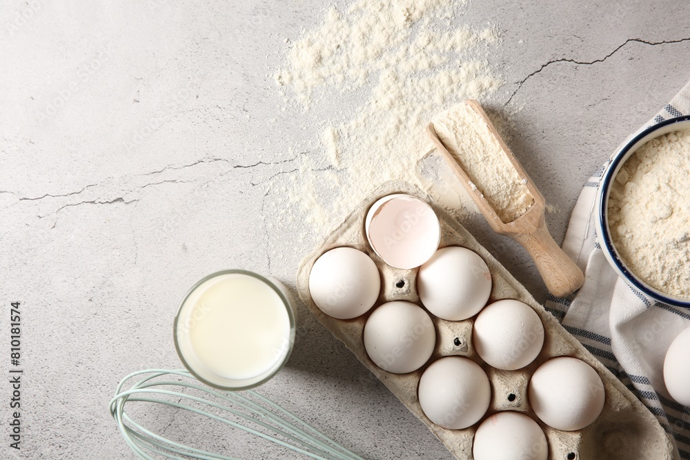 Making dough. Flour, eggs, milk and tools on light textured table, flat lay. Space for text Making dough. Flour, eggs, milk and tools on light textured table, flat lay. Space for text