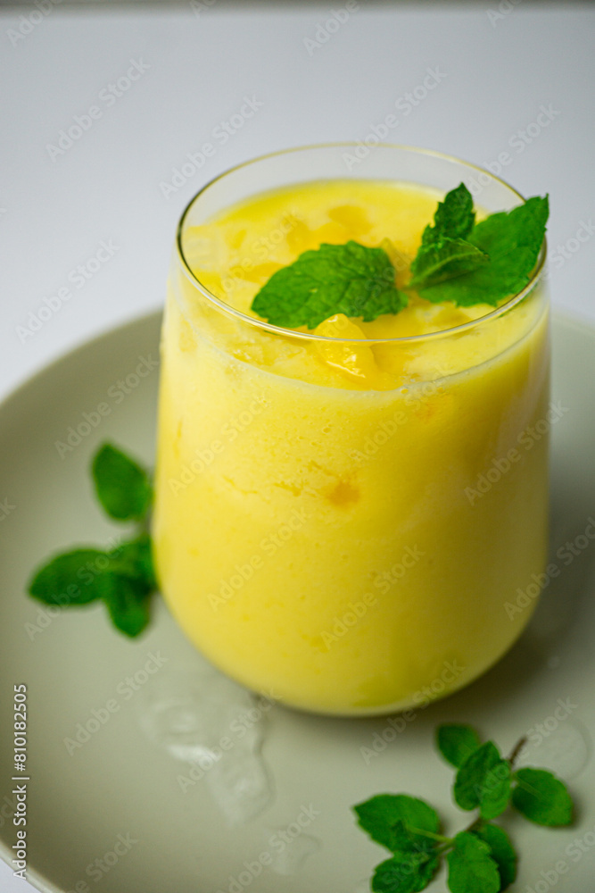 refreshing summer drink decorated with peppermint leaves - mango lassi drink refreshing summer drink decorated with peppermint leaves - mango lassi drink