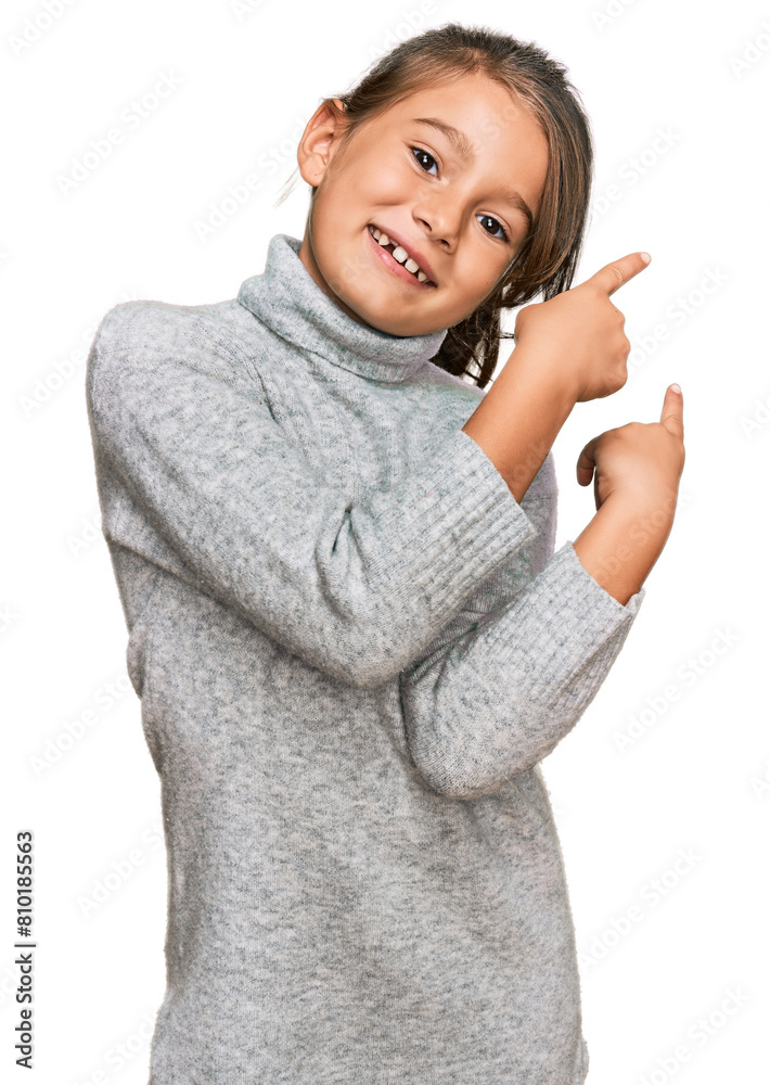 Little beautiful girl wearing casual turtleneck sweater smiling and looking at the camera pointing with two hands and fingers to the side. Little beautiful girl wearing casual turtleneck sweater smiling and looking at the camera pointing with two hands and fingers to the side.