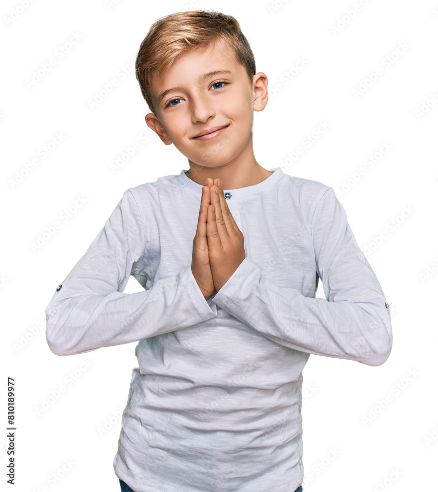 Little caucasian boy kid wearing casual clothes praying with hands together asking for forgiveness smiling confident. Little caucasian boy kid wearing casual clothes praying with hands together asking for forgiveness smiling confident.