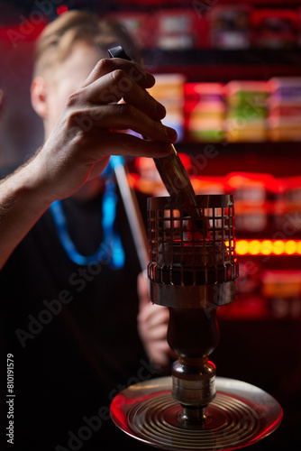 Person holding a hookah at a drinking establishment event