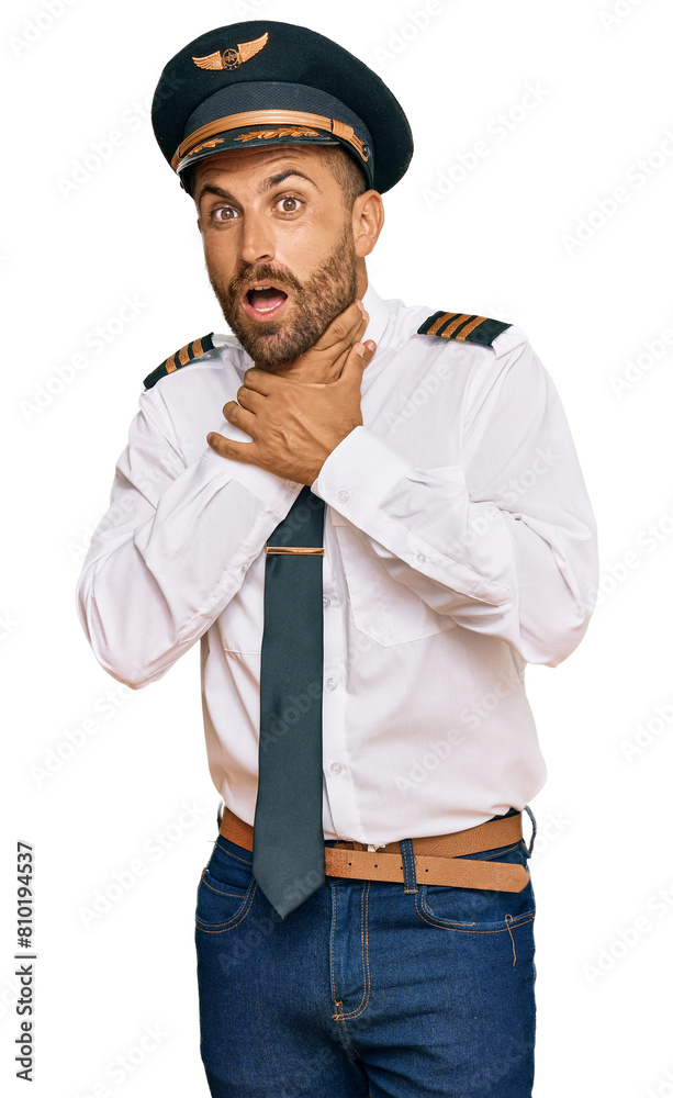 Handsome man with beard wearing airplane pilot uniform shouting and suffocate because painful strangle. health problem. asphyxiate and suicide concept. Handsome man with beard wearing airplane pilot uniform shouting and suffocate because painful strangle. health problem. asphyxiate and suicide concept.