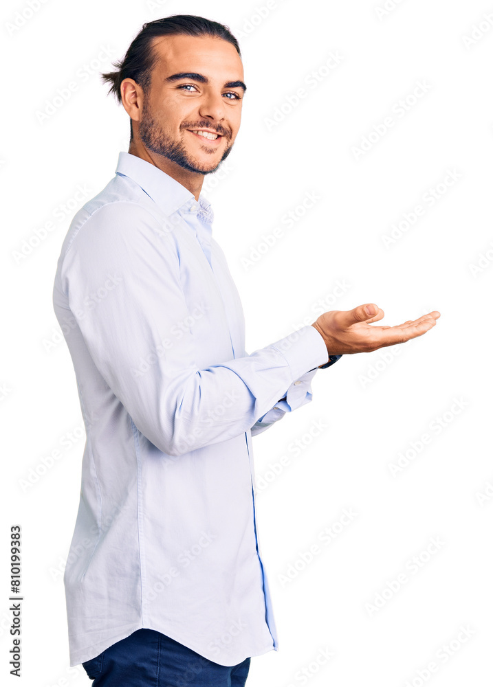 Young handsome man wearing business clothes pointing aside with hands open palms showing copy space, presenting advertisement smiling excited happy Young handsome man wearing business clothes pointing aside with hands open palms showing copy space, presenting advertisement smiling excited happy