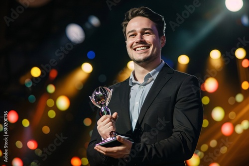 A successful businessman receiving an award on stage with a proud smile