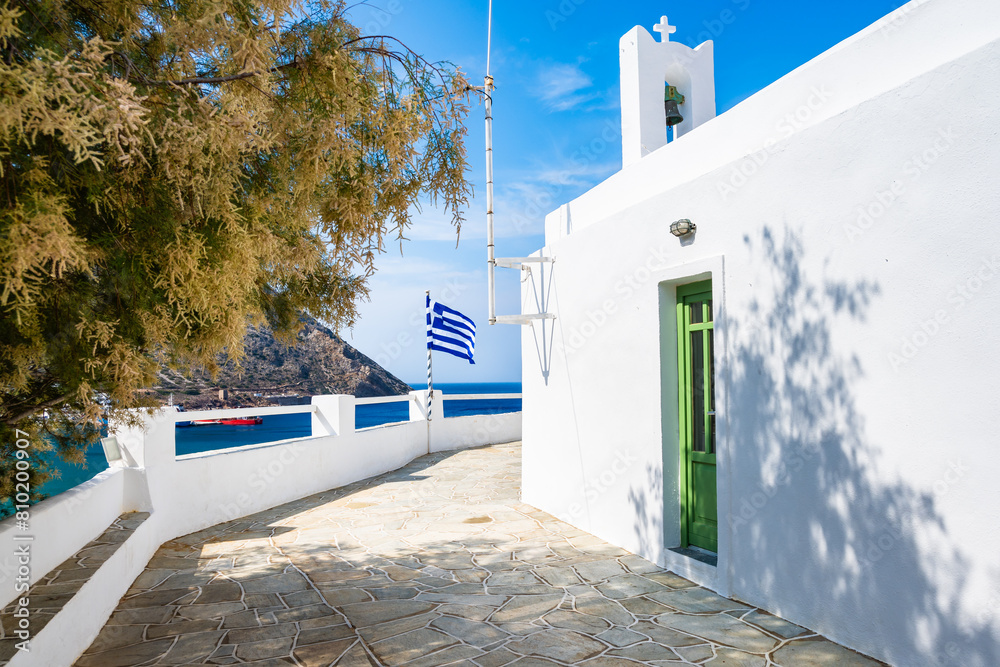 View of typical white small chapel in Kamares port, Sifnos, Cyclades Islands, Greece