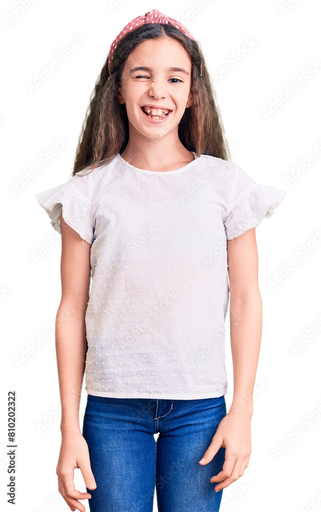 Cute hispanic child girl wearing casual white tshirt winking looking at the camera with sexy expression, cheerful and happy face. Cute hispanic child girl wearing casual white tshirt winking looking at the camera with sexy expression, cheerful and happy face.