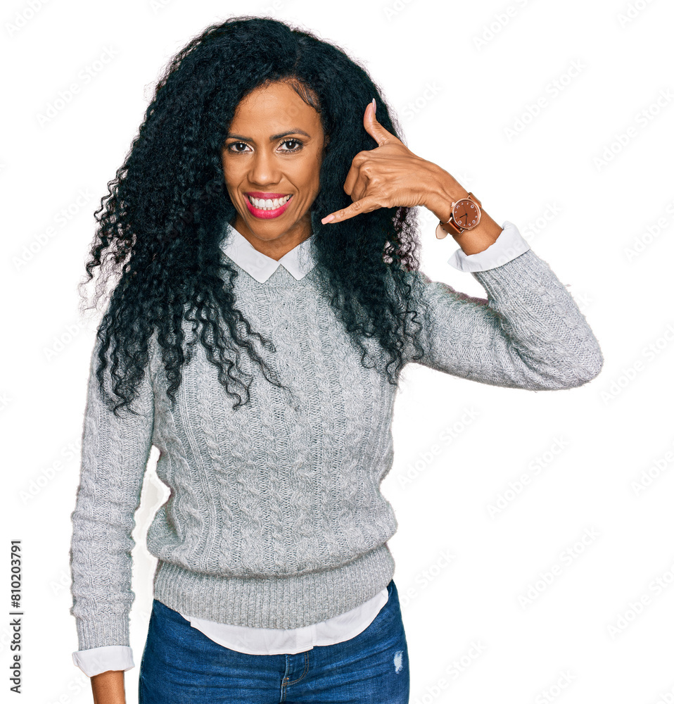 Middle age african american woman wearing casual clothes smiling doing phone gesture with hand and fingers like talking on the telephone. communicating concepts. Middle age african american woman wearing casual clothes smiling doing phone gesture with hand and fingers like talking on the telephone. communicating concepts.
