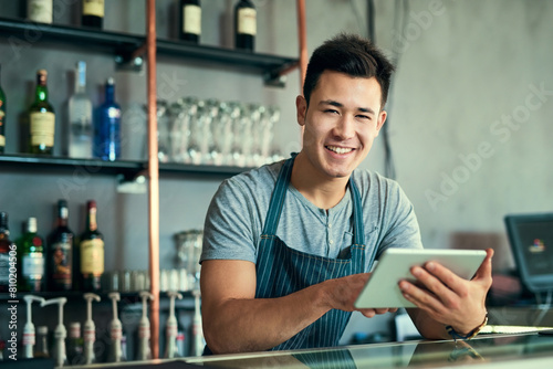 Portrait, Asian and man with tablet in restaurant as barista for online order, website and inventory for industry. Smile, Korean and male owner with digital, email and stock, sales or delivery shop