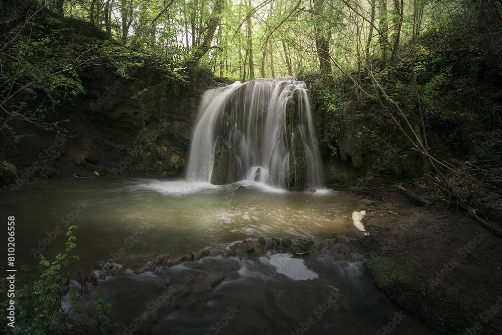 Fototapeta premium Waterfall of Altube inside a beech forest in the province of Alava, in the Basque Country, on a spring morning