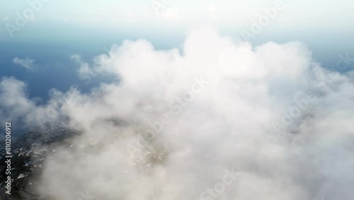 Vista aerea all’alba dal monte Epomeo a Ischia. Volo tra le nuvole con vista mare photo