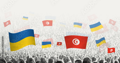 People waving flag of Tunisia and Ukraine, symbolizing Tunisia solidarity for Ukraine.