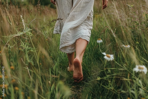 woman walking barefoot on soft grass connecting with nature through grounding practice promoting mindfulness and wellbeing lifestyle photography photo