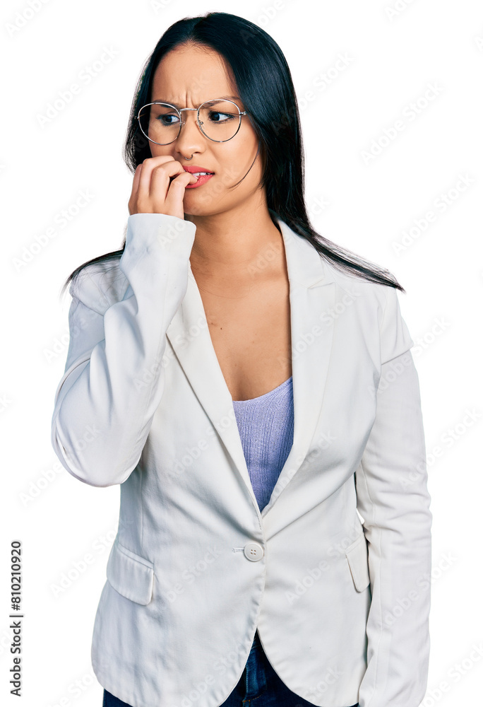 Beautiful hispanic woman with nose piercing wearing business jacket and glasses looking stressed and nervous with hands on mouth biting nails. anxiety problem. Beautiful hispanic woman with nose piercing wearing business jacket and glasses looking stressed and nervous with hands on mouth biting nails. anxiety problem.