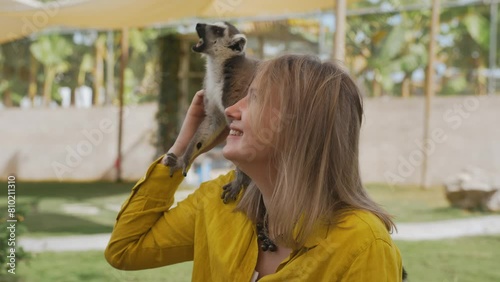 Woman with a lemur in a petting zoo. photo