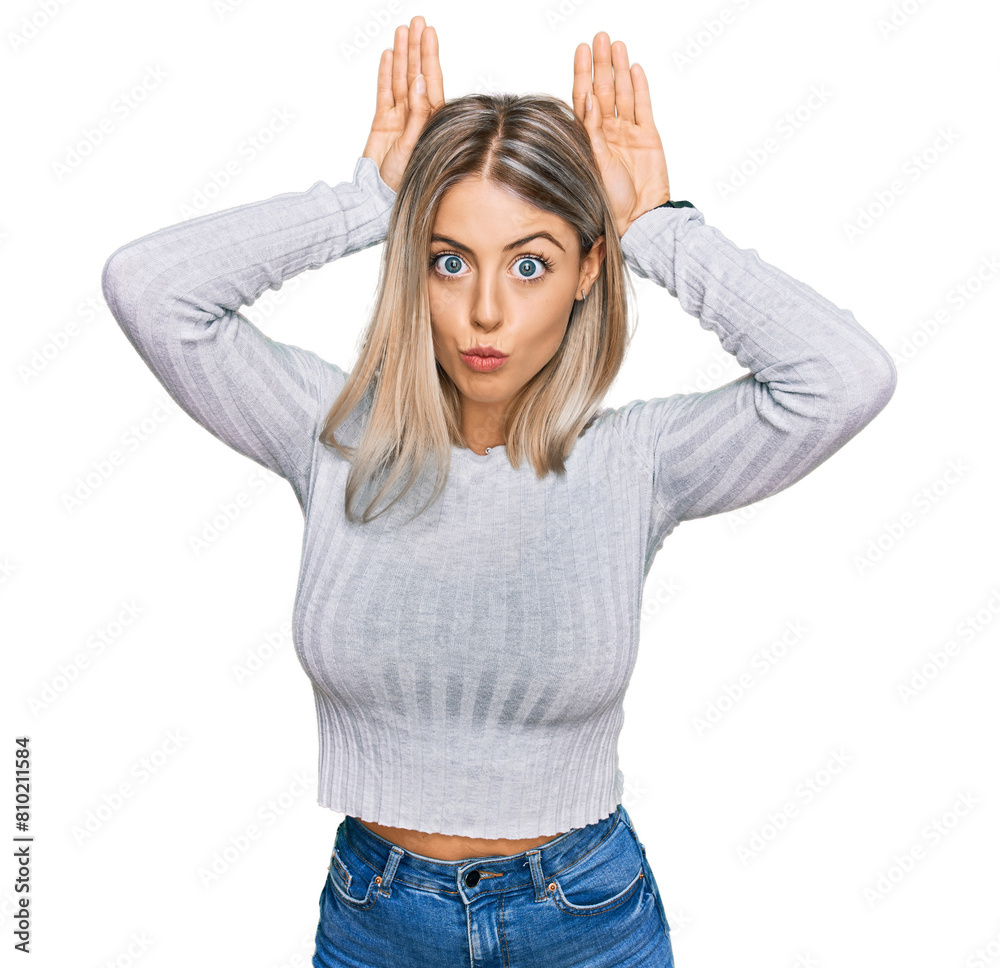 Beautiful blonde woman wearing casual clothes doing bunny ears gesture with hands palms looking cynical and skeptical. easter rabbit concept. Beautiful blonde woman wearing casual clothes doing bunny ears gesture with hands palms looking cynical and skeptical. easter rabbit concept.