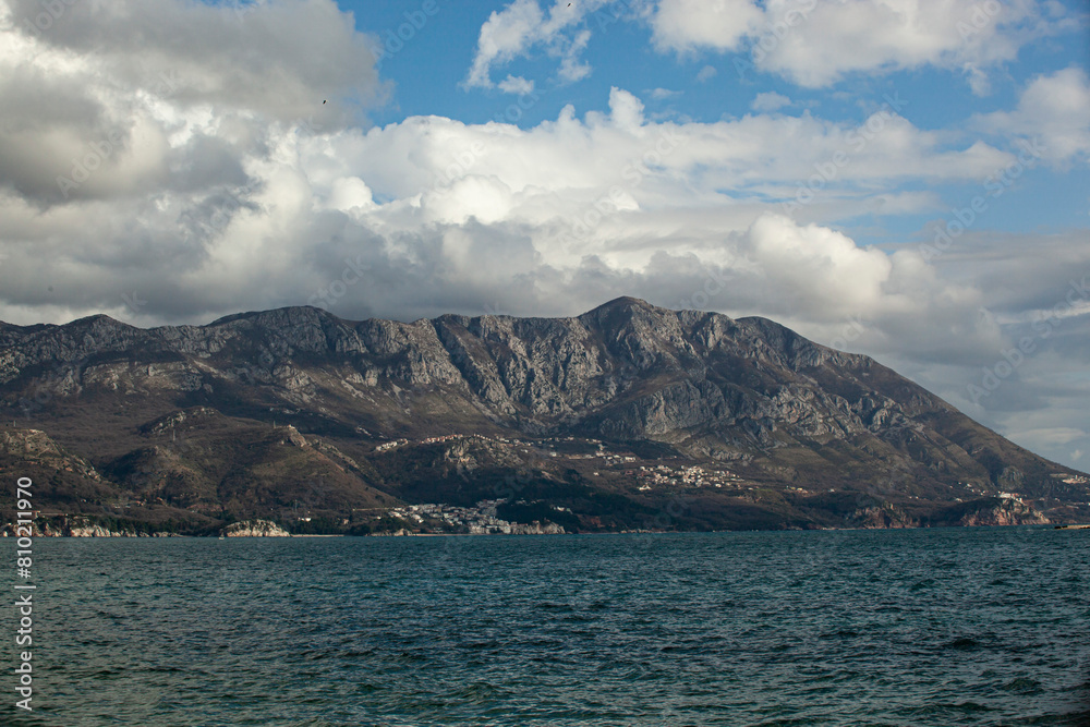 Spring in the mountains, beautiful mountain landscape. View of the mountain range and green trees. Summer, autumn and winter. Budva, Montenegro. Europe. Background. For text. Banner. Postcard. 