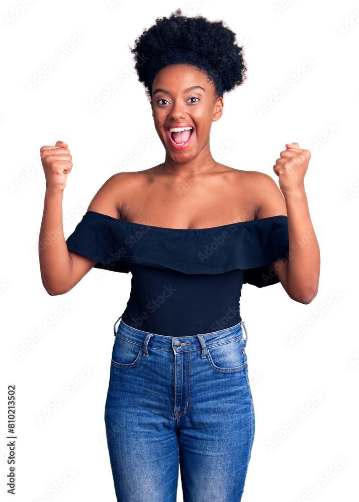 Young african american woman wearing casual clothes screaming proud, celebrating victory and success very excited with raised arms Young african american woman wearing casual clothes screaming proud, celebrating victory and success very excited with raised arms