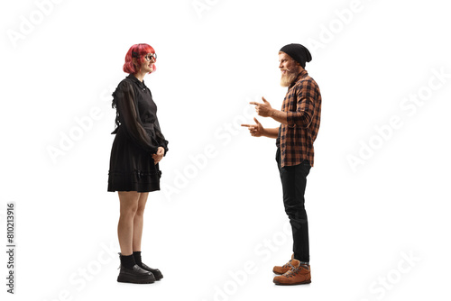 Hipster guy talking to a red-haired woman in a black dress