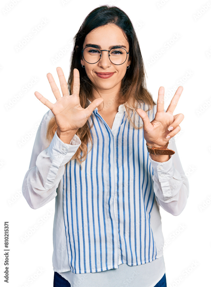 Beautiful hispanic woman wearing casual striped shirt showing and pointing up with fingers number eight while smiling confident and happy. Beautiful hispanic woman wearing casual striped shirt showing and pointing up with fingers number eight while smiling confident and happy.