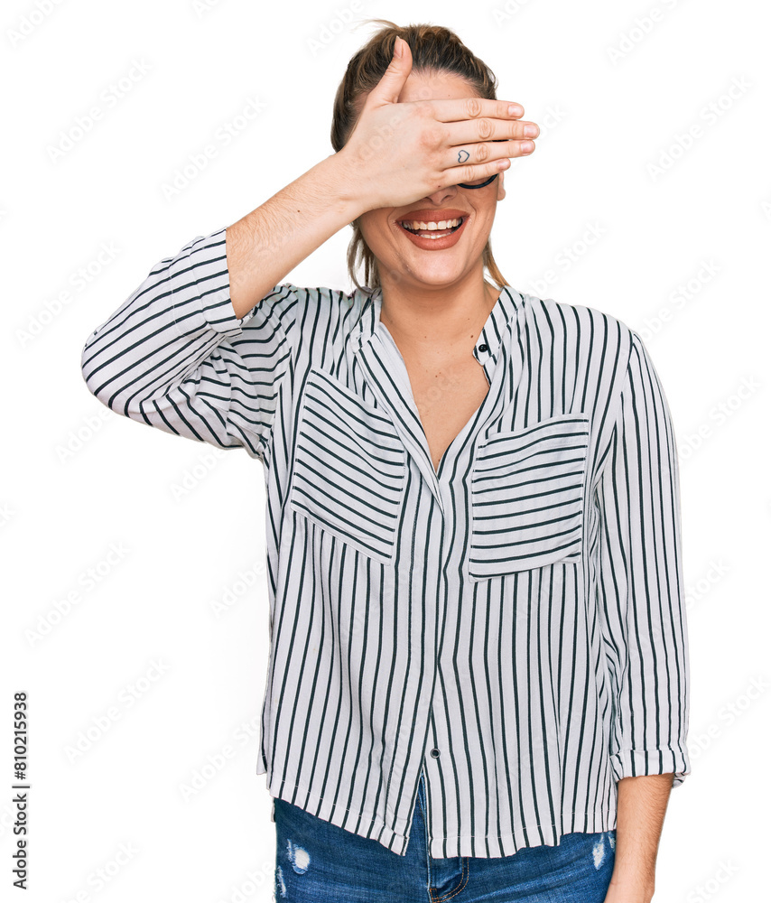 Young caucasian woman wearing business shirt and glasses smiling and laughing with hand on face covering eyes for surprise. blind concept. Young caucasian woman wearing business shirt and glasses smiling and laughing with hand on face covering eyes for surprise. blind concept.