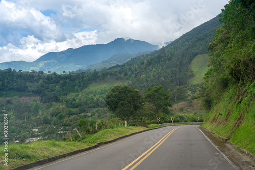 Road going down a hill in a Colombian landscape of mountains. photo