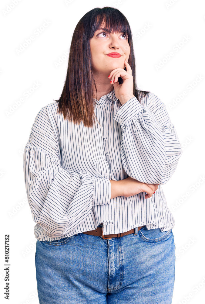 Young plus size woman wearing casual clothes with hand on chin thinking about question, pensive expression. smiling with thoughtful face. doubt concept. Young plus size woman wearing casual clothes with hand on chin thinking about question, pensive expression. smiling with thoughtful face. doubt concept.