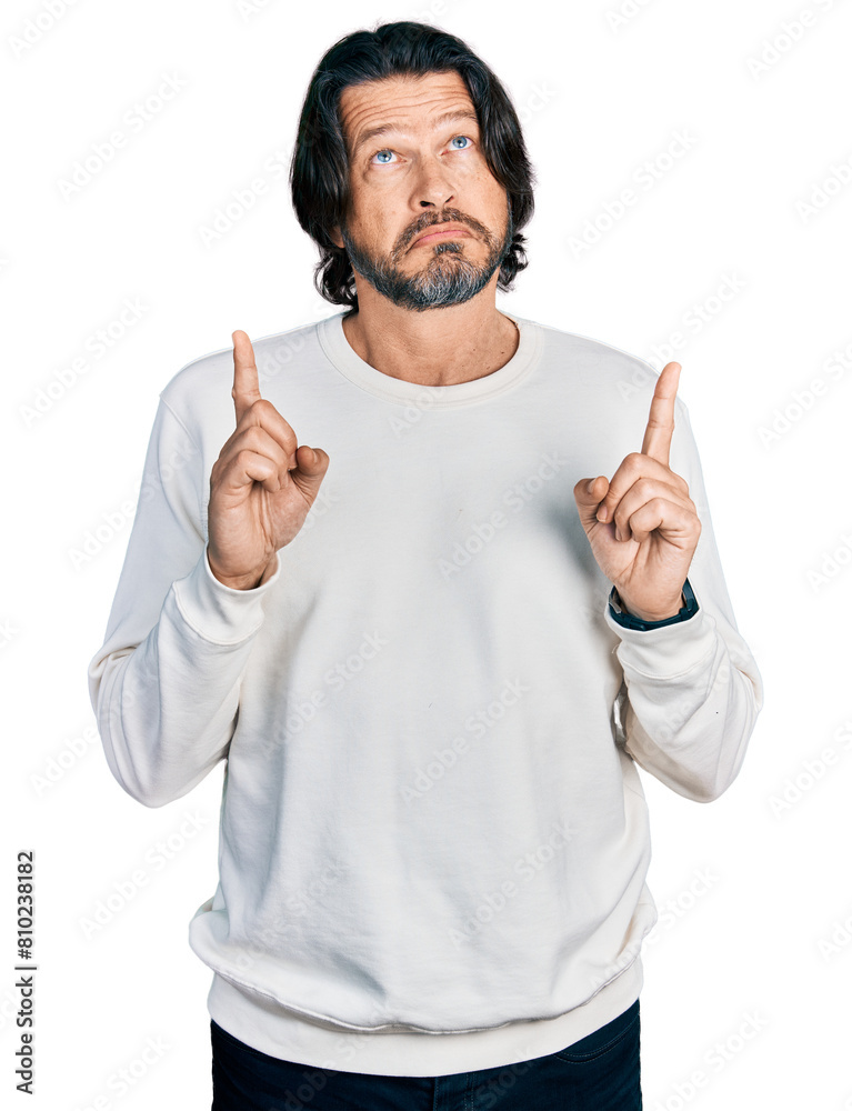 Middle age caucasian man wearing casual clothes pointing up looking sad and upset, indicating direction with fingers, unhappy and depressed.